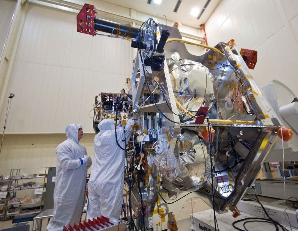 Technicians installing and inspecting electronics in the Juno spacecraft vault